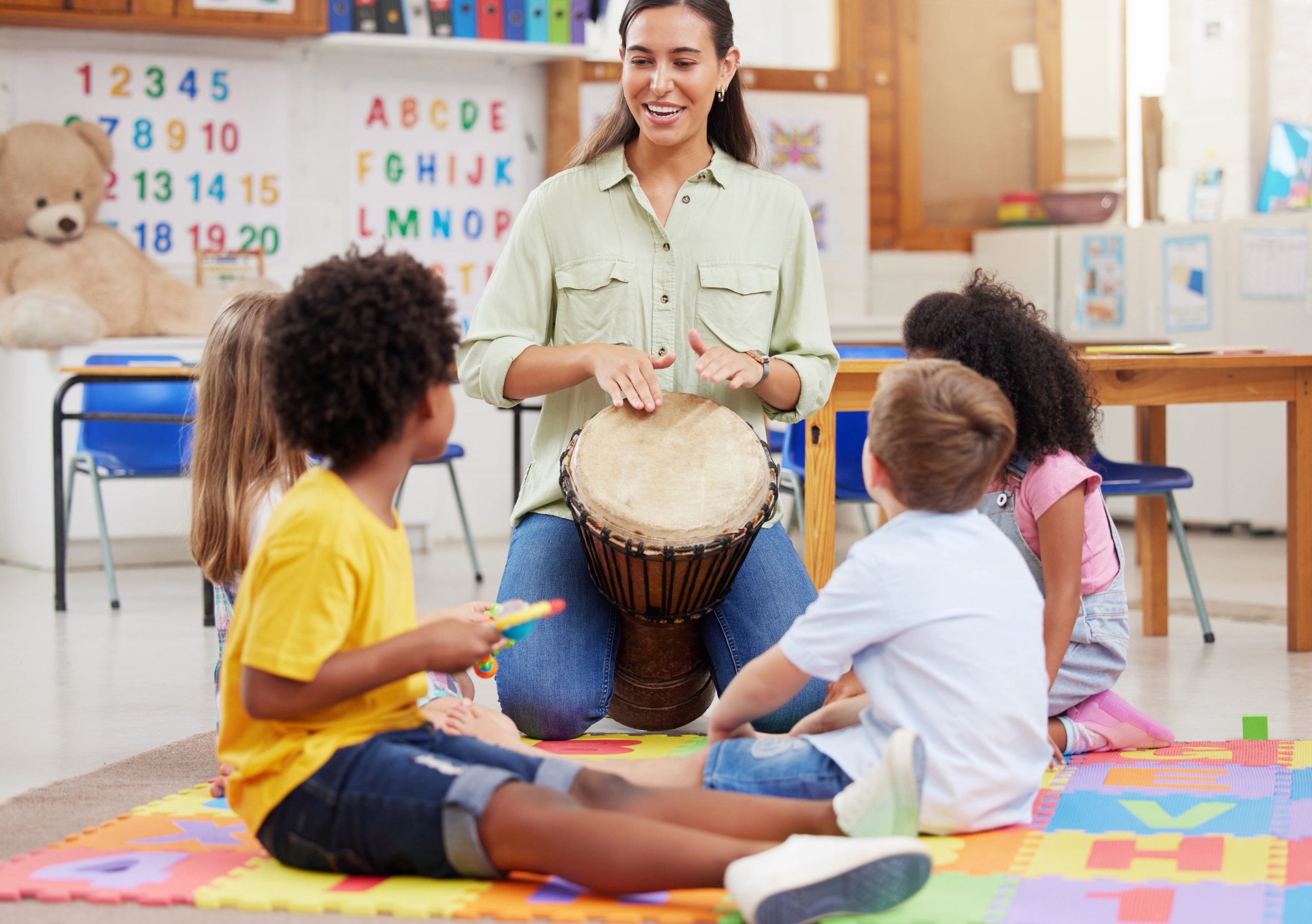 teacher-kids-play-drums-classroom-creative-learning-language-development-childhood-woman-children-instruments-teaching-music-sensory-education-group-activity-school
